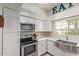 Bright updated kitchen with white cabinets, quartz countertops, and stainless steel appliances at 6885 E Cochise Rd # 127, Paradise Valley, AZ 85253