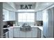 Modern kitchen with white cabinets, stainless steel appliances, and a farmhouse sink at 6885 E Cochise Rd # 127, Paradise Valley, AZ 85253