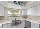Bright kitchen with white cabinets, stainless steel sink, and quartz countertops at 6885 E Cochise Rd # 127, Paradise Valley, AZ 85253