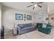Inviting living room with stacked stone fireplace, blue sofa, a ceiling fan, and decor at 6885 E Cochise Rd # 127, Paradise Valley, AZ 85253