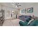 Comfortable living room with a blue sofa, ceiling fan, and bright natural light from the window at 6885 E Cochise Rd # 127, Paradise Valley, AZ 85253