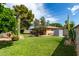 Large backyard featuring mature trees, desert plants, and a storage shed at 6902 E Cypress St, Scottsdale, AZ 85257
