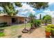 Spacious backyard featuring a covered patio, a swing, and manicured landscaping at 6902 E Cypress St, Scottsdale, AZ 85257