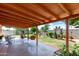 Inviting covered patio with a swing, seating area, and well-maintained backyard at 6902 E Cypress St, Scottsdale, AZ 85257