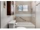 Bathroom featuring a white toilet, tub, tiled shower, and a mirrored medicine cabinet at 6902 E Cypress St, Scottsdale, AZ 85257
