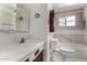 This bathroom features a vanity with decorative accents, neutral countertops, and a mirrored medicine cabinet at 6902 E Cypress St, Scottsdale, AZ 85257