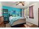 Bright bedroom features tropical décor, accent wall, and a ceiling fan for added comfort at 6902 E Cypress St, Scottsdale, AZ 85257