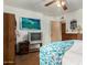 Cozy bedroom with retro TV and built-in storage offers a comfortable retreat at 6902 E Cypress St, Scottsdale, AZ 85257