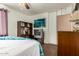 Comfortable bedroom features a vintage TV setup, neutral walls, and ample closet space for organized living at 6902 E Cypress St, Scottsdale, AZ 85257