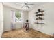 This bedroom offers a dedicated exercise area with open shelving and ample natural light at 6902 E Cypress St, Scottsdale, AZ 85257