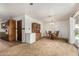 Spacious dining room with a wooden table set near kitchen entryway and backyard access at 6902 E Cypress St, Scottsdale, AZ 85257