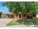 Charming single-story home with a tree-shaded front yard and a covered carport, offering comfortable and convenient living at 6902 E Cypress St, Scottsdale, AZ 85257