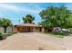 Well-maintained single-Gathering home with a spacious driveway, covered carport, and desert landscaping at 6902 E Cypress St, Scottsdale, AZ 85257