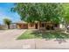 Charming single-story home with a well-maintained front yard and a mature shade tree at 6902 E Cypress St, Scottsdale, AZ 85257