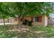 Landscaped front yard with lush green grass and mature trees, providing shade and curb appeal at 6902 E Cypress St, Scottsdale, AZ 85257