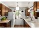Cozy kitchen with wood cabinets, laminate countertops, and views of the front yard at 6902 E Cypress St, Scottsdale, AZ 85257