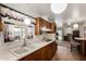 Bright kitchen featuring wood cabinetry, laminate counters, and an open layout at 6902 E Cypress St, Scottsdale, AZ 85257