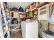 Compact laundry area with washer, dryer, and storage shelves for organization at 6902 E Cypress St, Scottsdale, AZ 85257