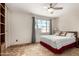 Bright bedroom with a ceiling fan, large window, and neutral-toned walls at 6902 E Cypress St, Scottsdale, AZ 85257