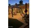 Cozy outdoor seating on tile patio with grass and ambient lighting at 7921 E Bonita Dr, Scottsdale, AZ 85250