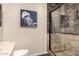 This bathroom features an updated shower, modern shower door, and nautical themed decor at 7921 E Bonita Dr, Scottsdale, AZ 85250