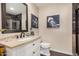 Well-lit bathroom featuring vanity with beige countertop, framed mirror, and nautical themed decorations at 7921 E Bonita Dr, Scottsdale, AZ 85250
