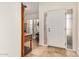 Bright foyer with tile flooring, a white front door with sidelight, and decorative furnishings at 7921 E Bonita Dr, Scottsdale, AZ 85250