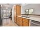 Bright kitchen area featuring light wood cabinetry, stainless steel appliances and access to a large patio at 7921 E Bonita Dr, Scottsdale, AZ 85250