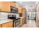 Well-equipped kitchen with stainless steel appliances, natural wood cabinets, and ample counter space at 7921 E Bonita Dr, Scottsdale, AZ 85250