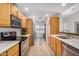 Galley kitchen featuring light wood cabinetry, stainless steel appliances and tile flooring at 7921 E Bonita Dr, Scottsdale, AZ 85250