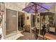 Outdoor patio area with brick pavers, shade umbrella, and unique decor, providing a cozy retreat at 7921 E Bonita Dr, Scottsdale, AZ 85250