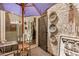 This charming patio features decorative wall hangings, tile pavers, and a metal security door at 7921 E Bonita Dr, Scottsdale, AZ 85250