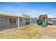 Large backyard featuring a covered patio, well-kept lawn, and a play structure at 845 W Shannon St, Chandler, AZ 85225