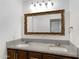 Double sink bathroom with granite countertop, ample mirror, and dark wood cabinets at 845 W Shannon St, Chandler, AZ 85225