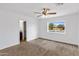 Spacious bedroom with neutral carpet, bathroom access, and window view at 845 W Shannon St, Chandler, AZ 85225
