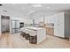Bright kitchen featuring stainless steel appliances, white cabinets, light wood flooring, and a skylight at 8544 E Heatherbrae Dr, Scottsdale, AZ 85251