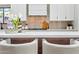 Up close, kitchen includes a white countertop, modern backsplash, and fresh floral arrangement at 8544 E Heatherbrae Dr, Scottsdale, AZ 85251