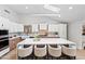 Modern kitchen boasts white cabinets, stainless steel appliances, and a large island with seating at 8544 E Heatherbrae Dr, Scottsdale, AZ 85251