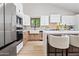 Bright kitchen with stainless steel appliances, a farmhouse sink, and light wood floors at 8544 E Heatherbrae Dr, Scottsdale, AZ 85251