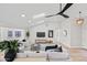 Bright and airy living room with a sleek ceiling fan and seamless connection to the kitchen at 8544 E Heatherbrae Dr, Scottsdale, AZ 85251