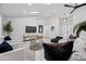 Cozy living room with a large sofa, stylish accents, and a view of the backyard at 8544 E Heatherbrae Dr, Scottsdale, AZ 85251