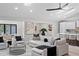 Stylish living room with chic decor, modern ceiling fan, and seamless flow to the kitchen at 8544 E Heatherbrae Dr, Scottsdale, AZ 85251