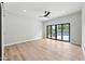 Bright living room featuring sliding glass doors to the backyard swimming pool at 8544 E Heatherbrae Dr, Scottsdale, AZ 85251