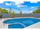 Refreshing pool area featuring a vibrant blue pool, poolside seating, and desert landscaping at 8544 E Heatherbrae Dr, Scottsdale, AZ 85251