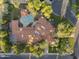 Stunning aerial view of a large property featuring a pool, lush landscaping, and a unique tile roof design at 8815 N 65Th St, Paradise Valley, AZ 85253