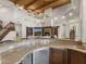 Indoor bar area with beverage cooler overlooking the living room with fireplace at 8815 N 65Th St, Paradise Valley, AZ 85253