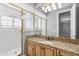 Bathroom featuring glass enclosed shower and vanity with gold hardware and framed mirror at 8815 N 65Th St, Paradise Valley, AZ 85253