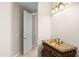 Powder room with decorative vanity with copper sink and ornate mirror at 8815 N 65Th St, Paradise Valley, AZ 85253