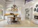 Large dining room featuring a decorative light fixture, table, and view to the kitchen at 8815 N 65Th St, Paradise Valley, AZ 85253