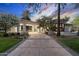 Inviting home featuring a curved driveway and well-kept landscaping leading to a covered entrance at 8815 N 65Th St, Paradise Valley, AZ 85253